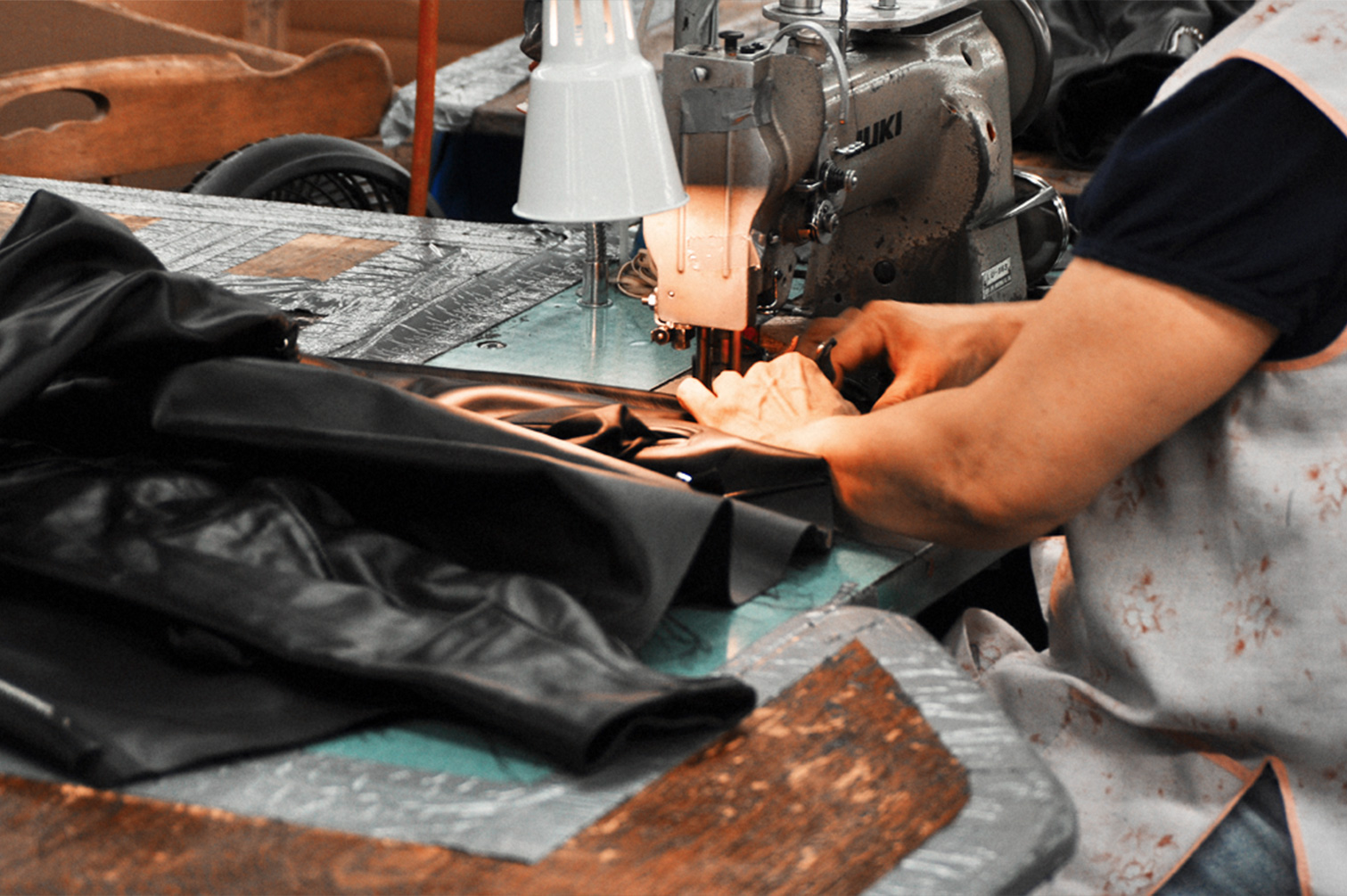 Woman at a sewing machine assembling jackets